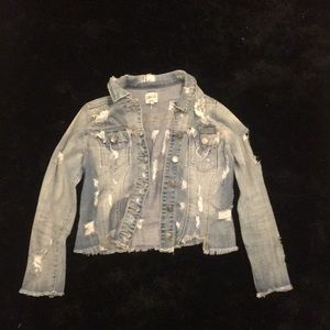 Ripped jean jacket .